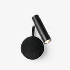 This black Clérachic wall sconce sits on a plain white backdrop, its arm angled upward.