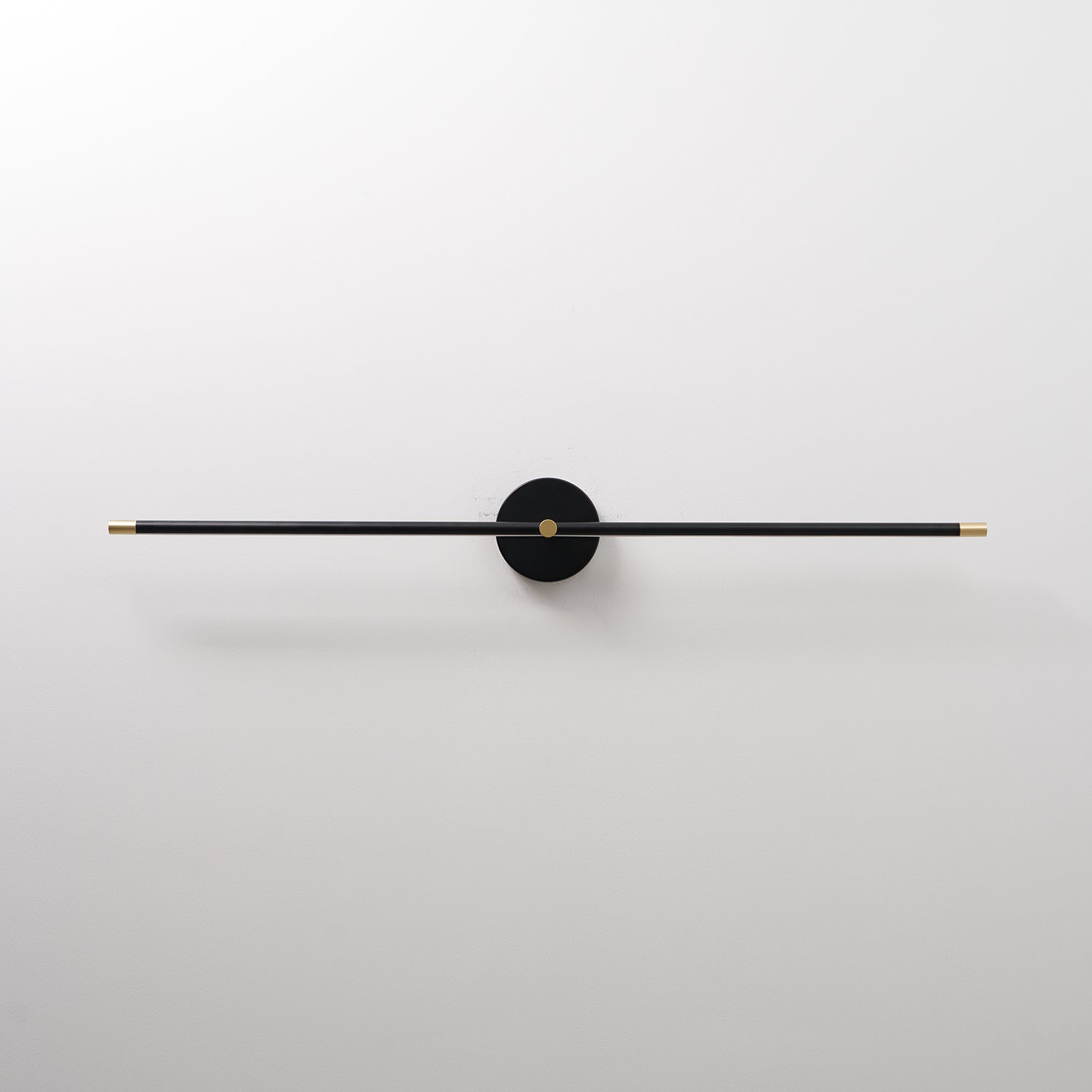 Minimalist linear wall lamp mounted in a modern bathroom