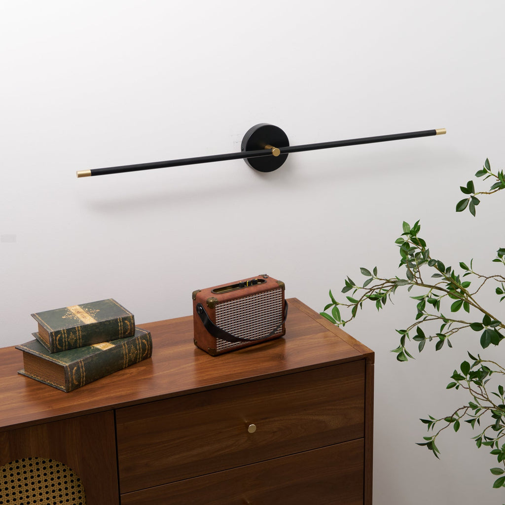 Linear wall lamp glowing warmly in a dim bathroom