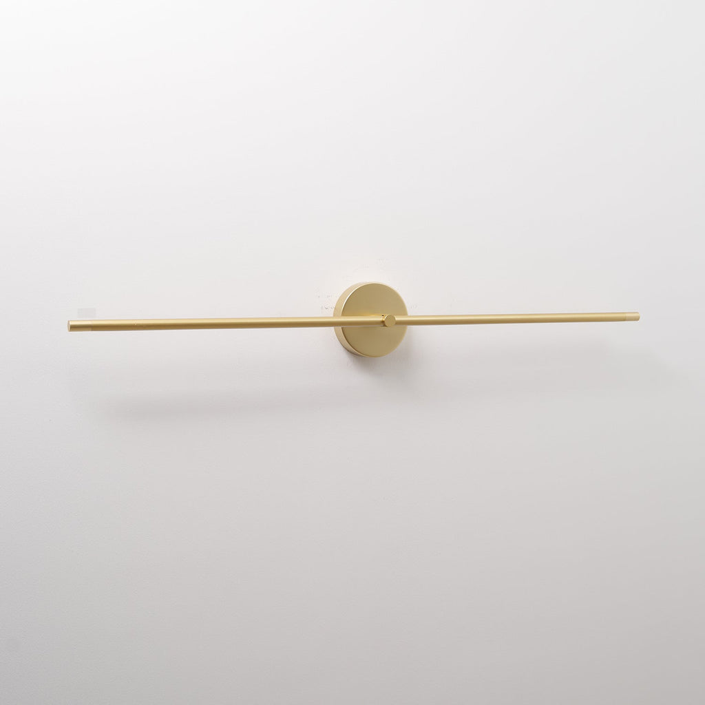Linear LED wall lamp above a mirror reflecting soft light