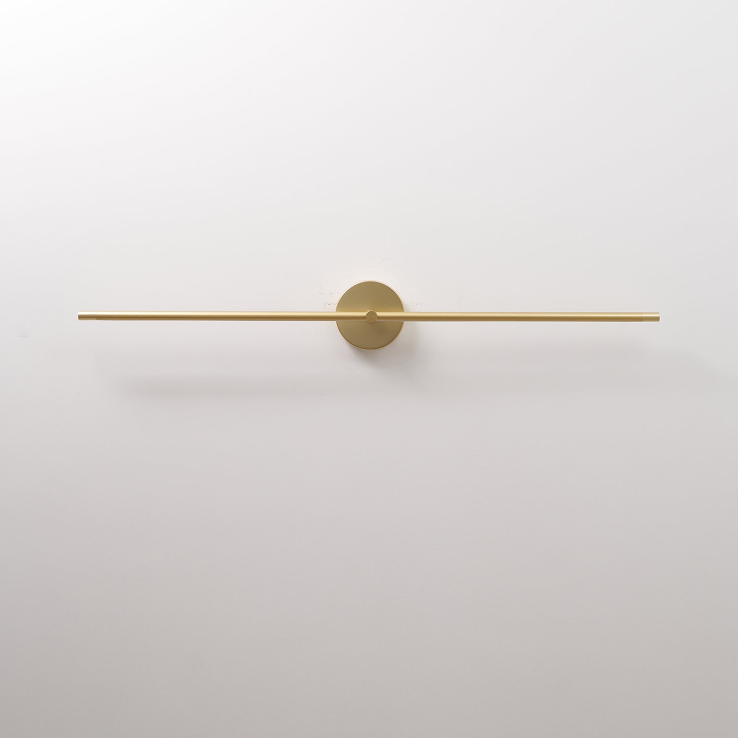 Slim linear LED wall lamp shown in warm ambient glow