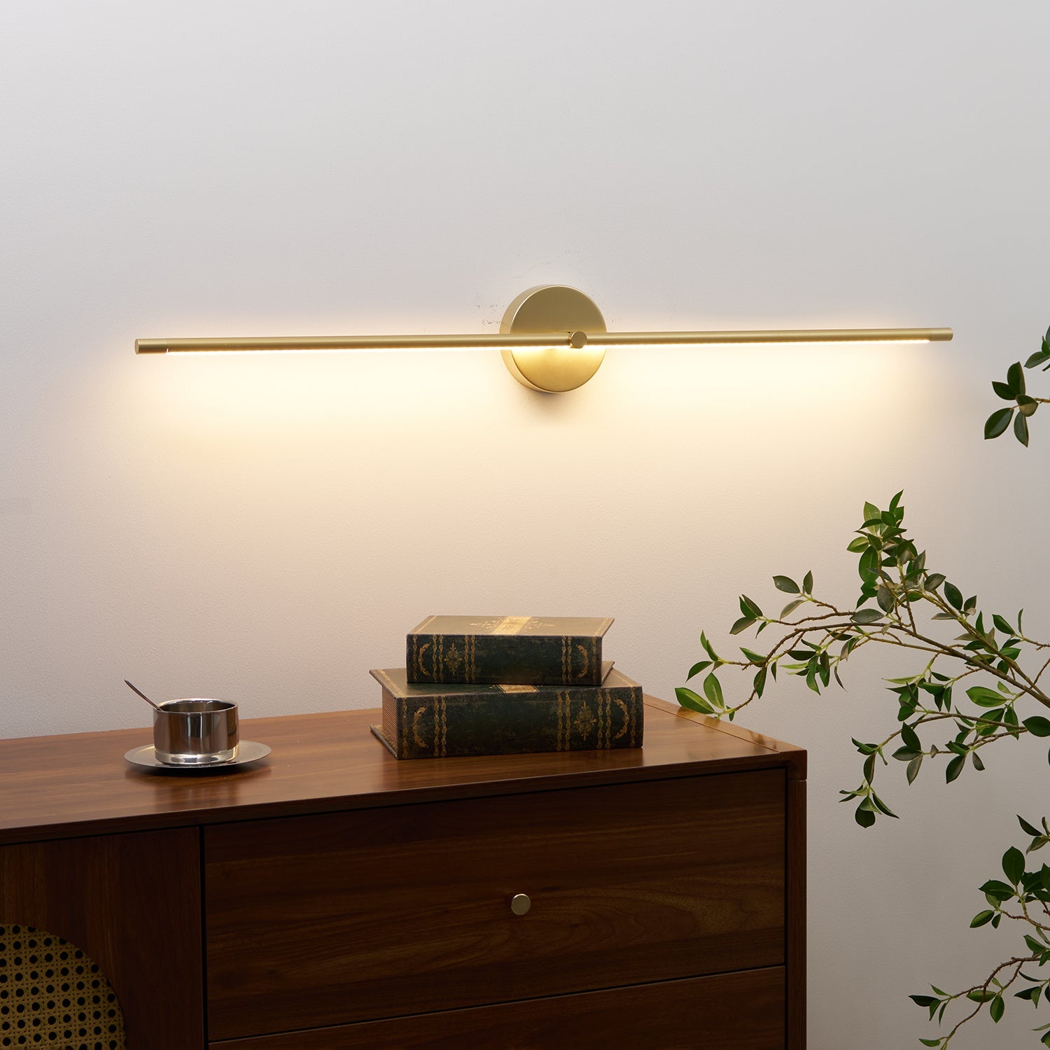 Linear wall lamp lighting a framed picture on the wall