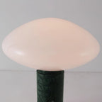 Clérachic table lamp shown in close-up, the frosted shade's underside meeting the green marble column below.