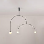 Mobile chandelier shown lit with soft ambient glass globes