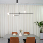 Graphic chandelier with white glass globes on black frame
