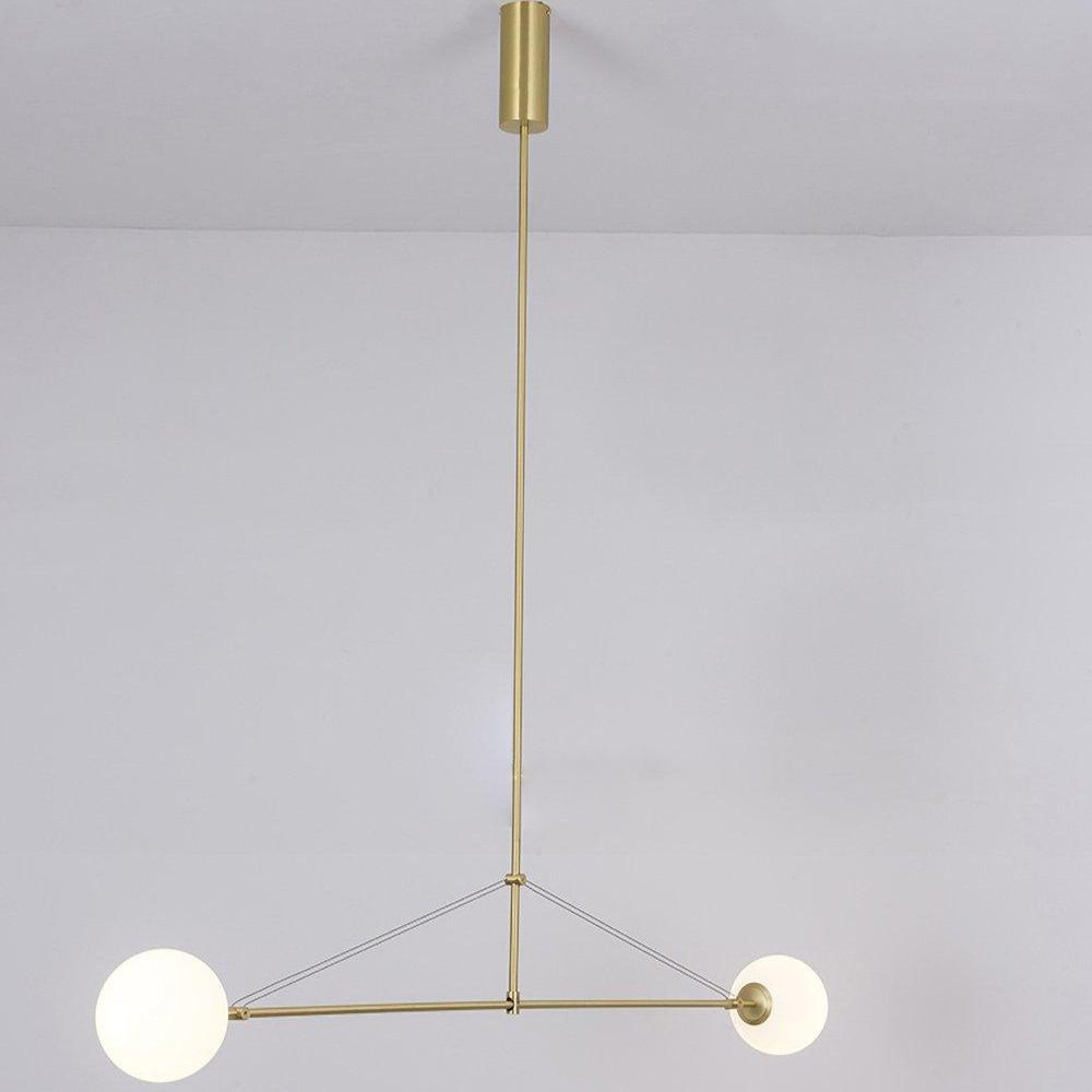 Mobile chandelier lit warmly above an open living space