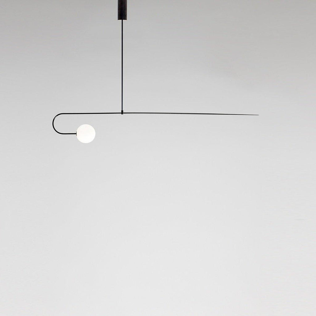 Mobile chandelier with brass arms and glowing glass globes