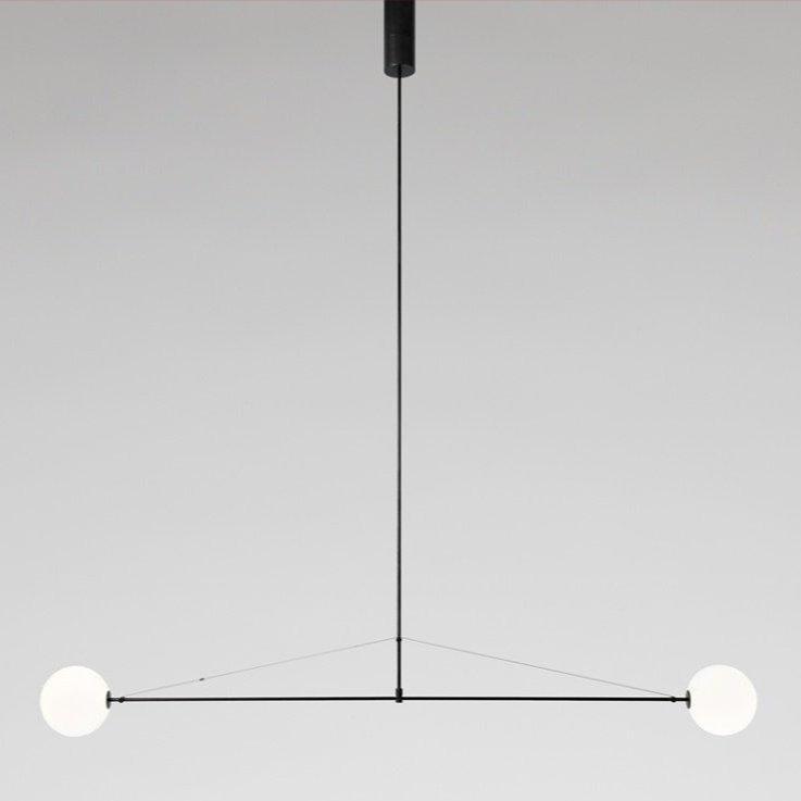 Minimalist chandelier with opaline diffusers in a styled room