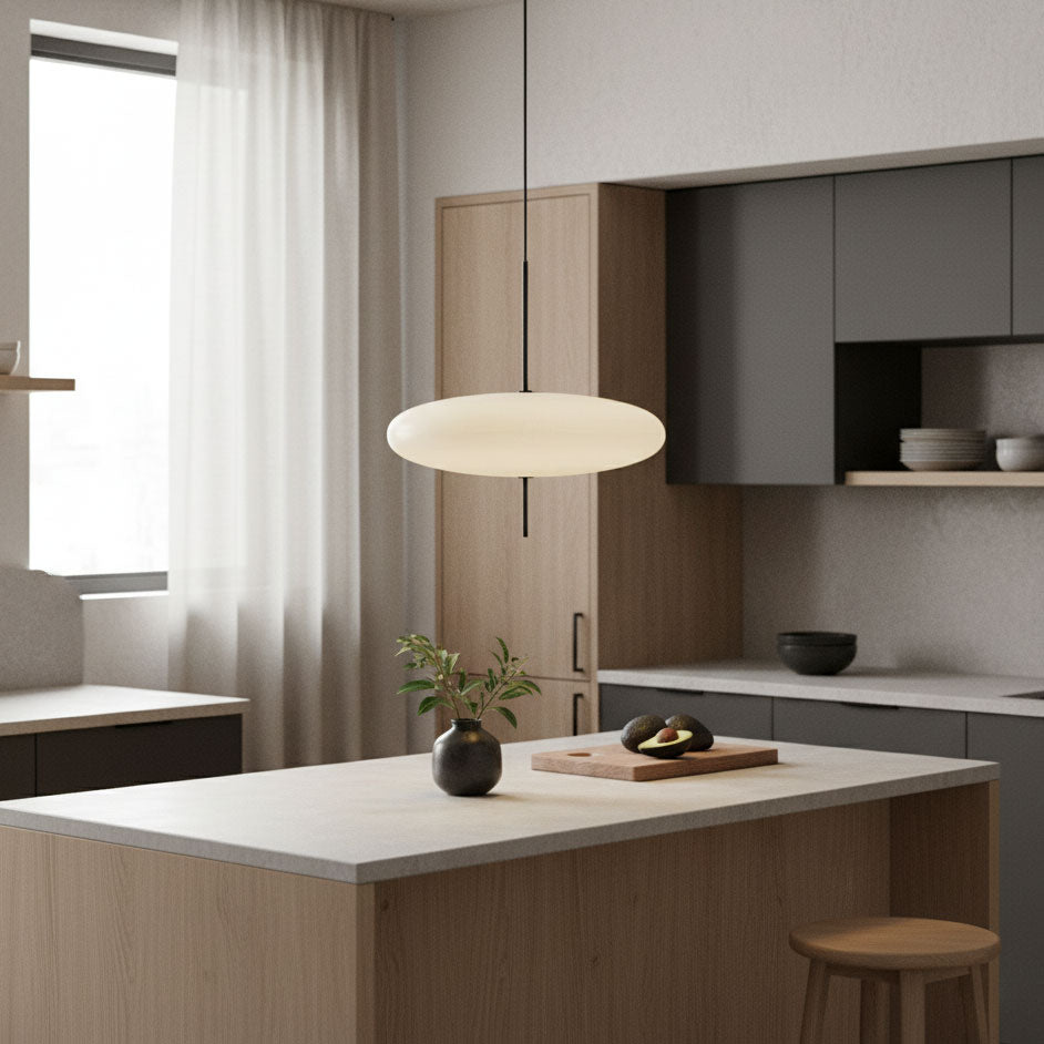 Disc pendant light shown over a kitchen island