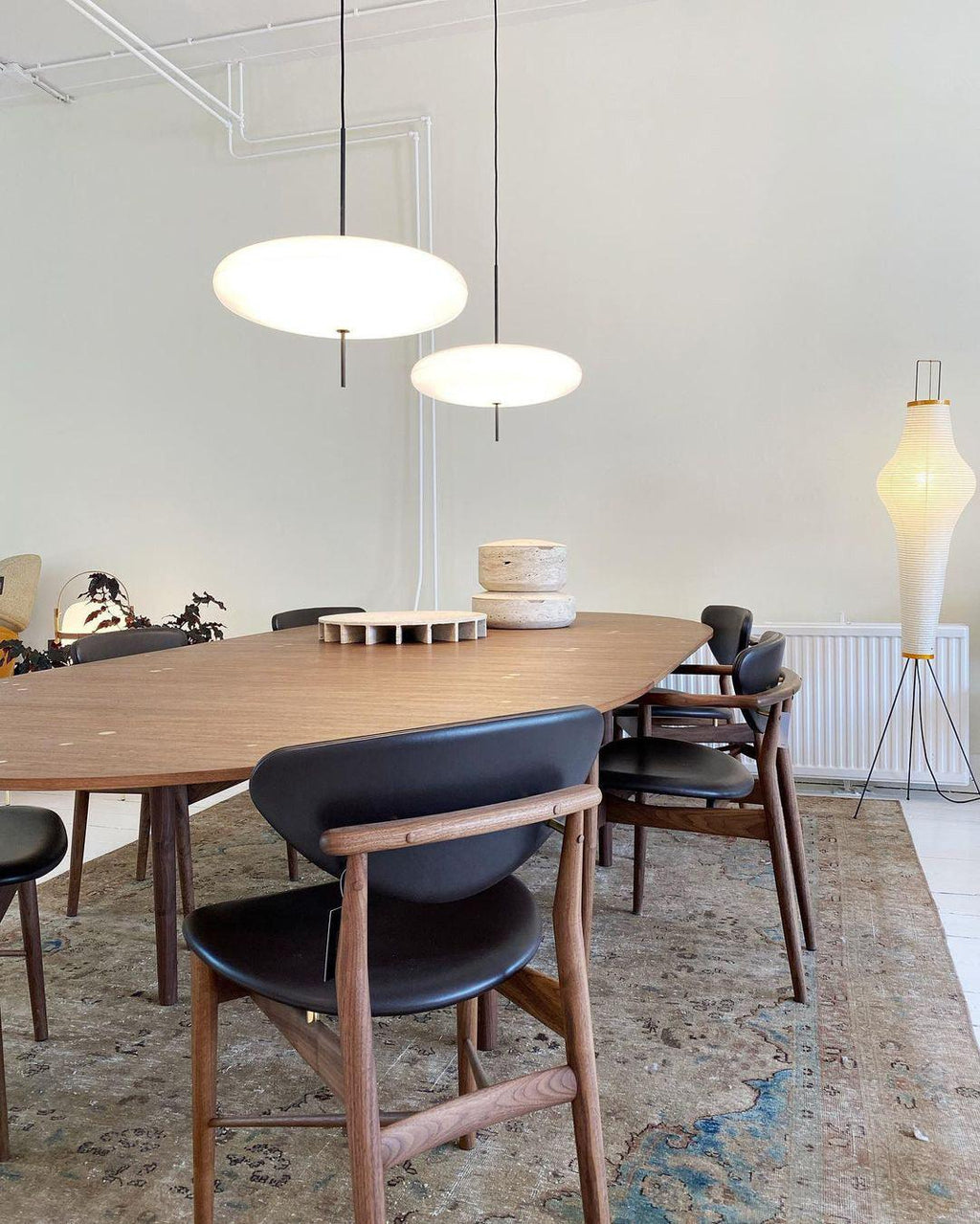 Disc pendant light styled above a dining setting