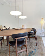 Disc pendant light styled above a dining setting