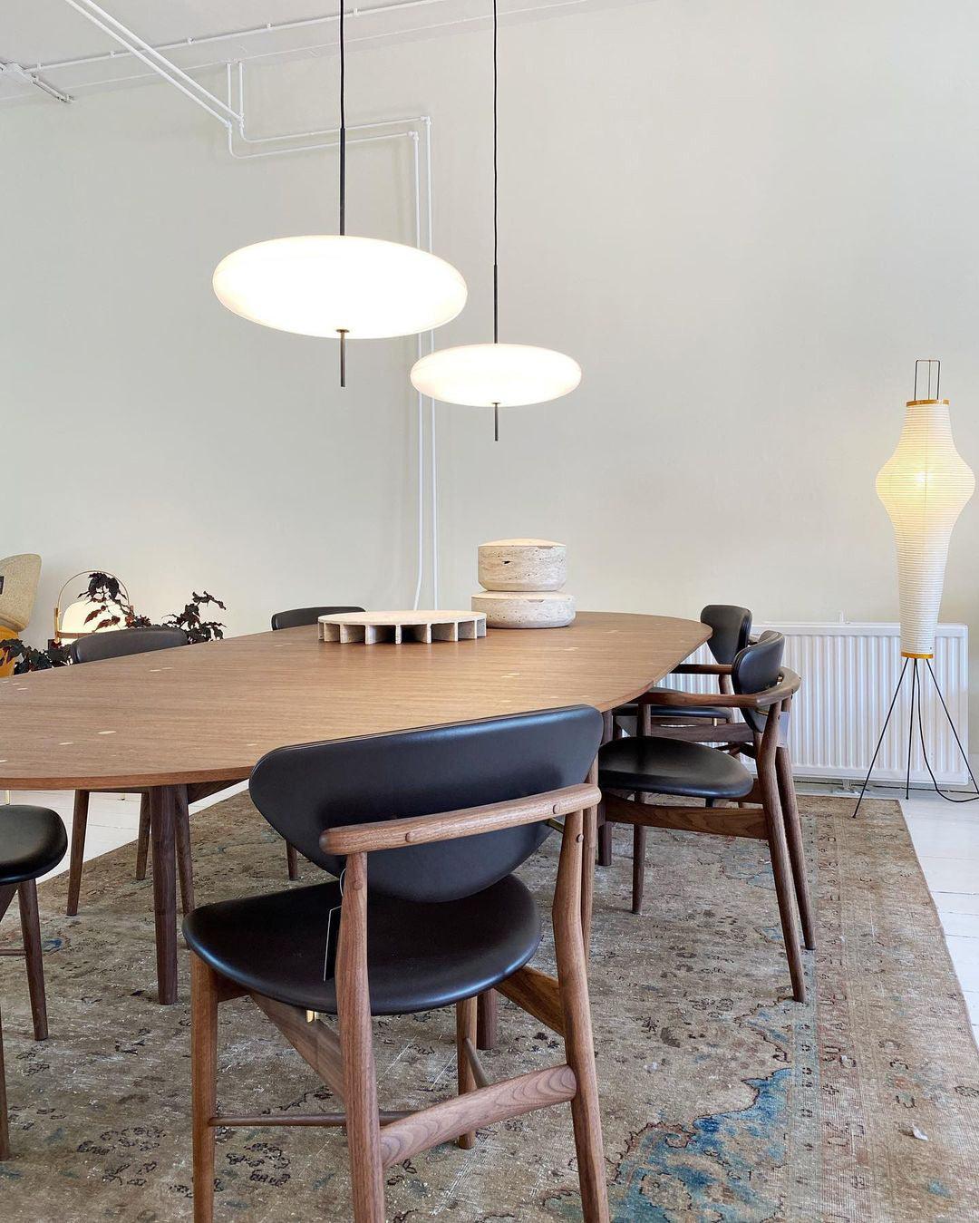 Disc pendant light styled above a dining setting