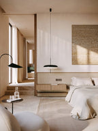 Disc pendant light glowing above a seating area
