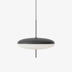 Opal disc pendant light suspended from a black canopy
