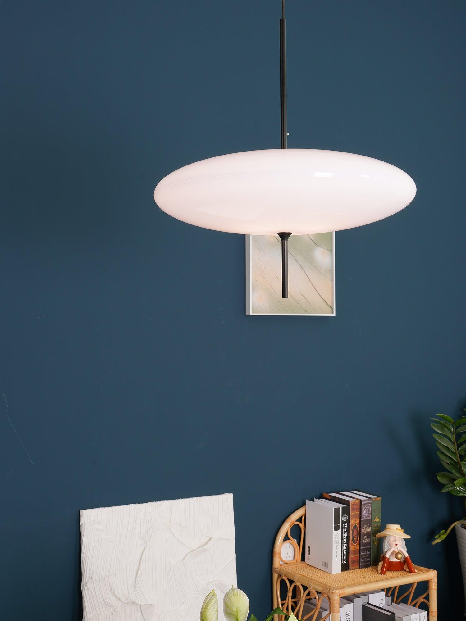 Elliptical opal pendant light suspended in a room