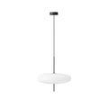 Opalescent disc pendant light glowing softly over a table