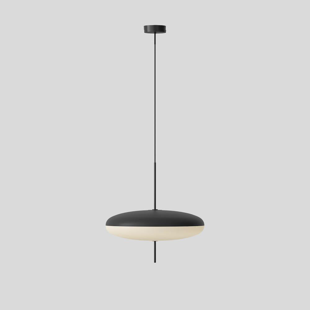 Opal disc pendant light shown lit in a dim room