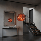 Molten-form pendant light lit to reveal reflective surface