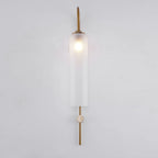 Modern glass wall lamp shown with warm glow in an interior