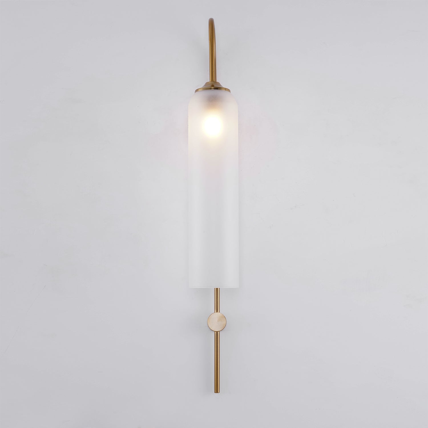 Modern glass wall lamp shown with warm glow in an interior