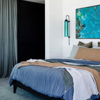 Modern glass wall lamp styled against a painted wall