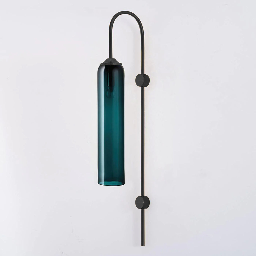 Modern glass wall lamp with black arm shown lit