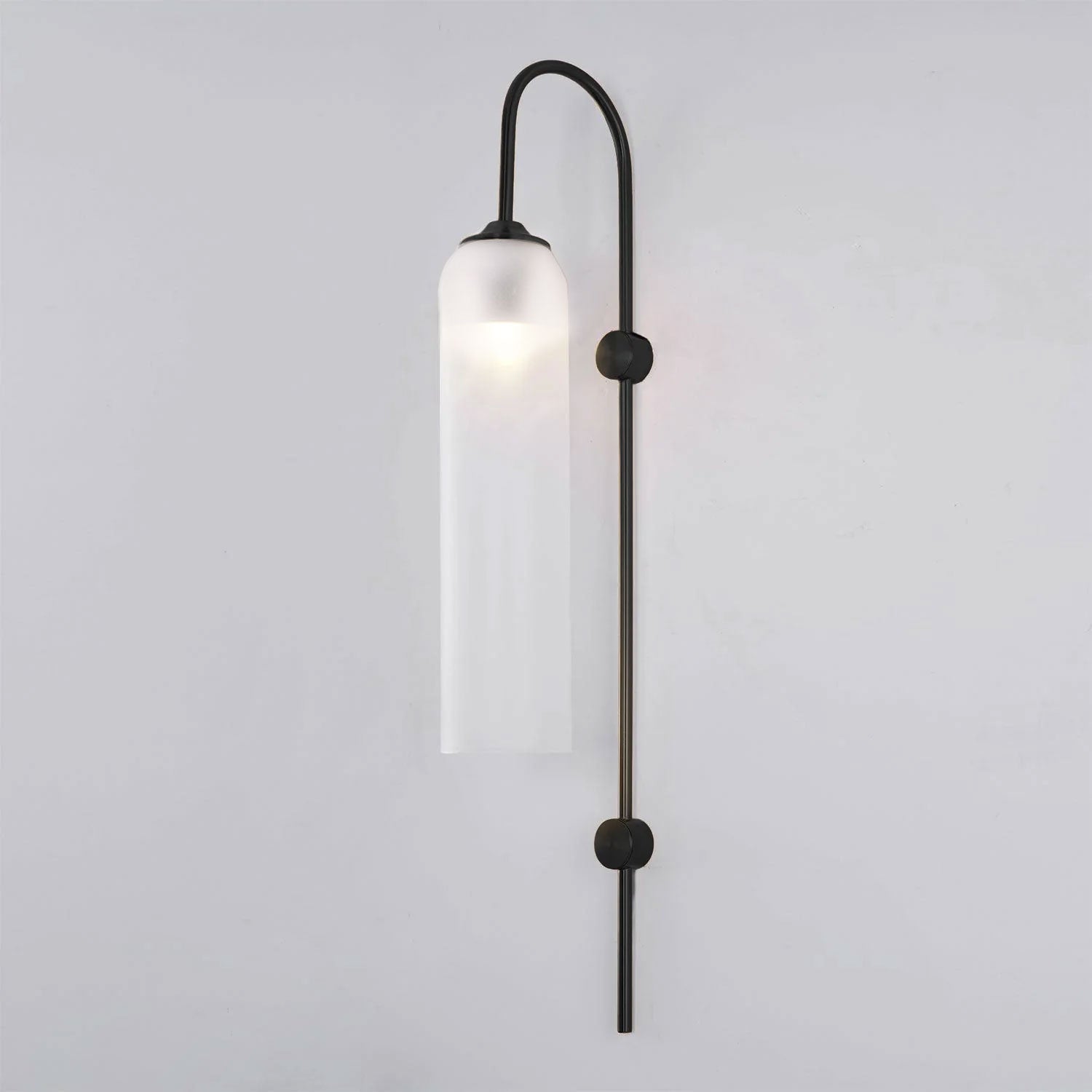 Modern glass wall lamp styled beside a bedside table
