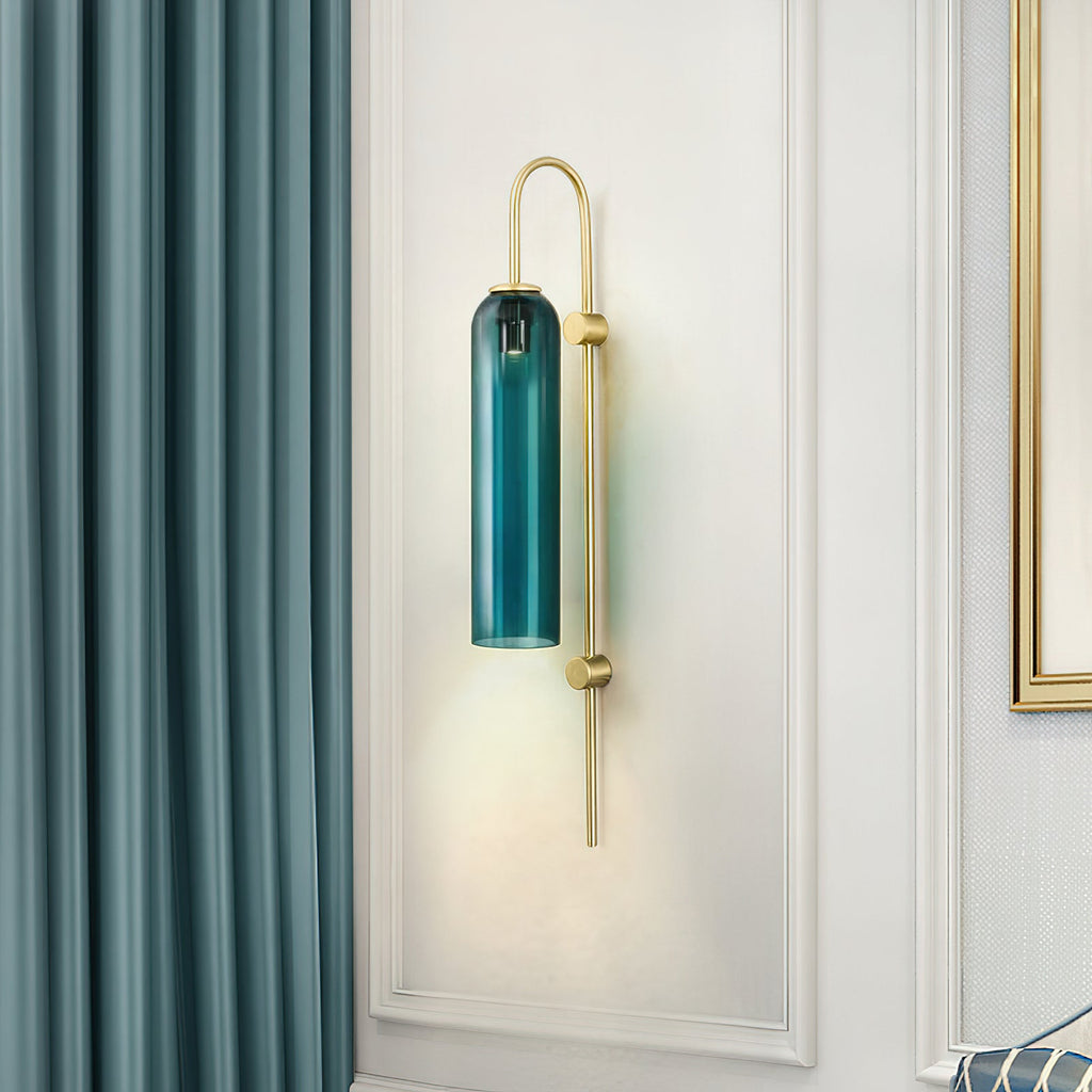 Modern glass wall lamp glowing warm through the mouth-blown cylinder
