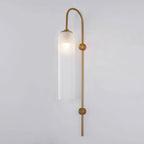 Modern glass wall lamp mounted above a console