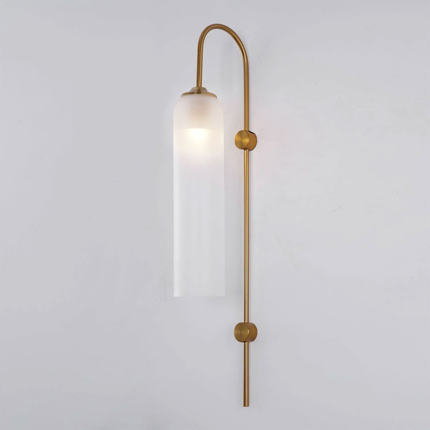 Modern glass wall lamp mounted above a console