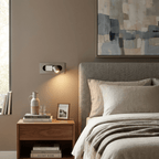 LED bedside reading light casting a soft warm glow at the headboard