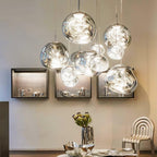Sculptural molten pendant light shade with a reflective finish