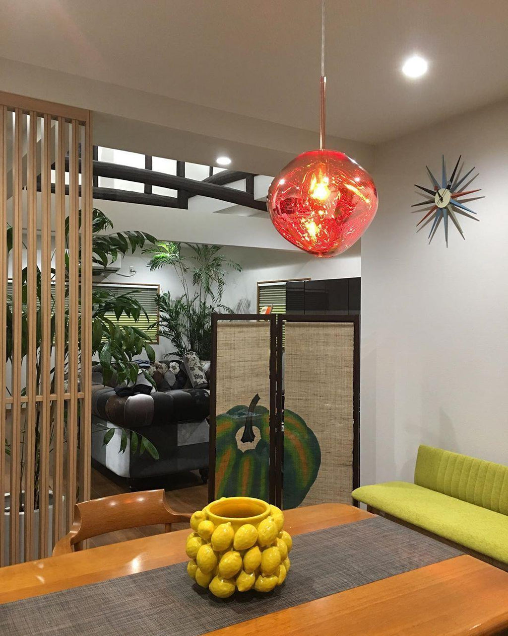 Molten silver pendant light with a glossy mirror finish