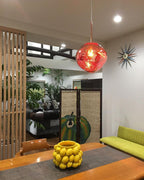 Molten silver pendant light with a glossy mirror finish