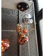 Sculptural molten pendant light shade with a mirror sheen