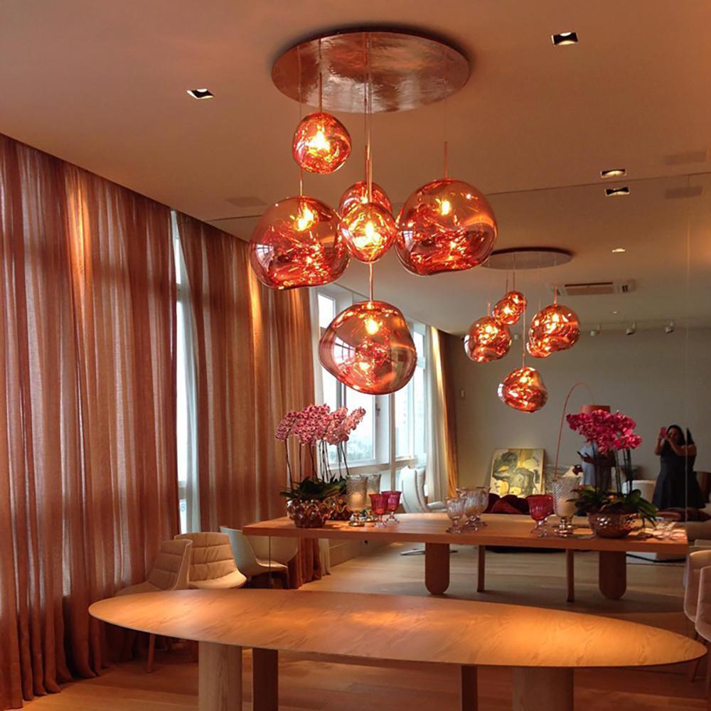Molten silver pendant light shade catching reflected light