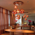 Molten silver pendant light shade catching reflected light