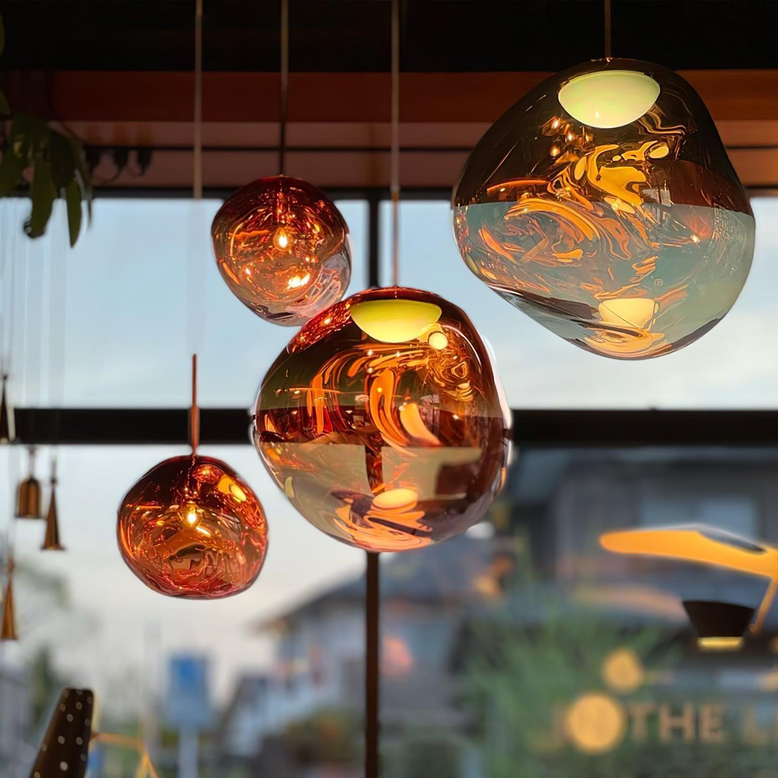 Molten pendant light illuminated above a dining setting