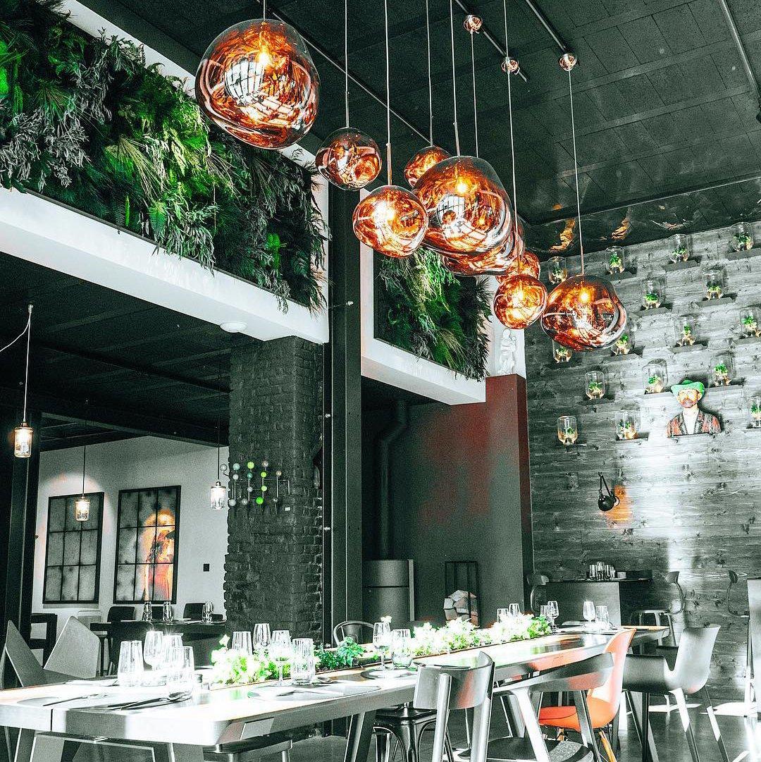 Lava pendant light glowing over a styled dining setting