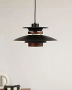 Close view of the black shades and walnut ring on this Clérachic pendant near a coffee cup.