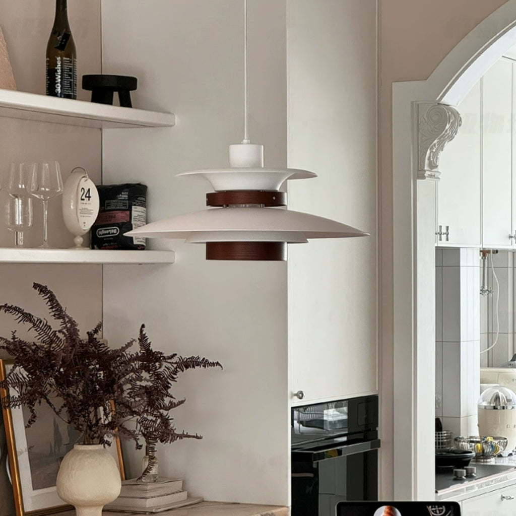 A white Clérachic pendant hangs near open shelving with wine glasses and dried flowers.