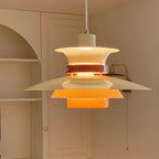 Close view of the lit beige shades on this Clérachic pendant beside arched wall shelving.