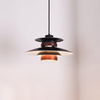 Close view of the lit black shades and walnut ring on this Clérachic pendant.