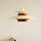 Close view of a beige Clérachic pendant hanging above a vintage-style radio prop.