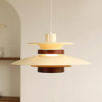 A lit beige Clérachic pendant hangs in a bright room with an arched alcove.