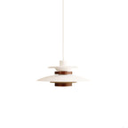 A white Clérachic pendant with a walnut ring, shown small on a plain white backdrop.