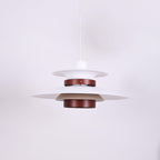 Close view of the white shades and walnut ring on this Clérachic pendant, unlit.