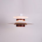 Close view of the lit white shades and walnut ring on this Clérachic pendant.
