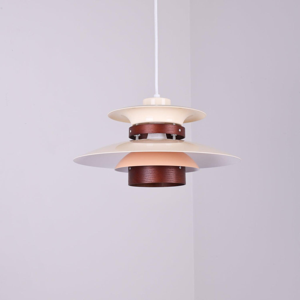 Close view of the lit beige shades and walnut ring on this Clérachic pendant.