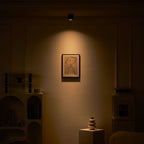 Modupoint ceiling light shown lit in a warm white tone in a styled interior